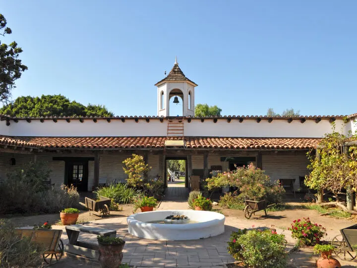 old town San Diego museum with Spanish architecture, plants and brick pathways in historic setting