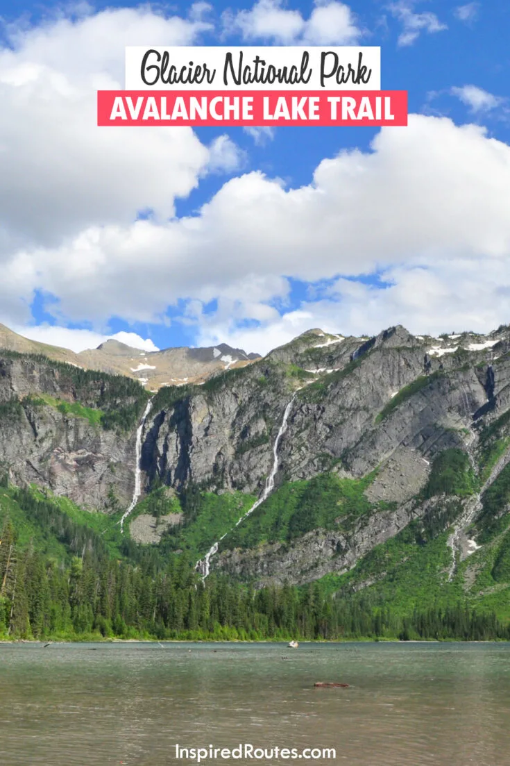 glacier national park avalanche lake trail with mountain and lake scene blue sky puffy clouds