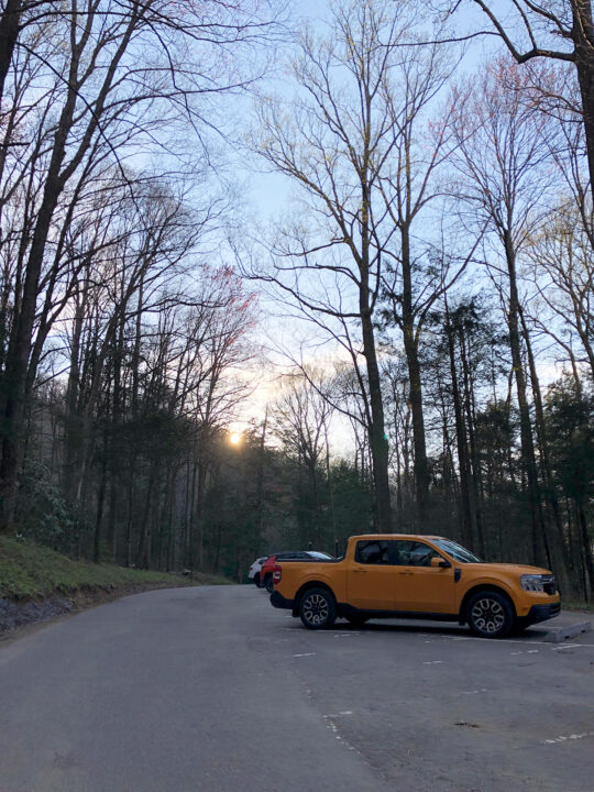 Grotto Falls parking lot with orange truck concrete and bare trees