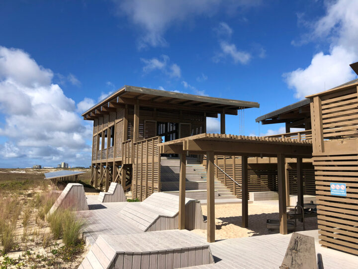 Gulf Shores State Park pavilion interactive displays with wooden building along sand dunes