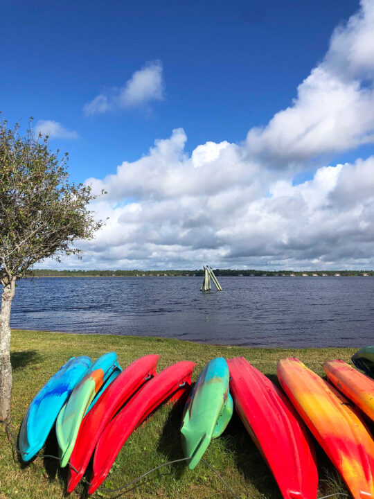 lake Shelby in distance with multi colored kayaks in foreground