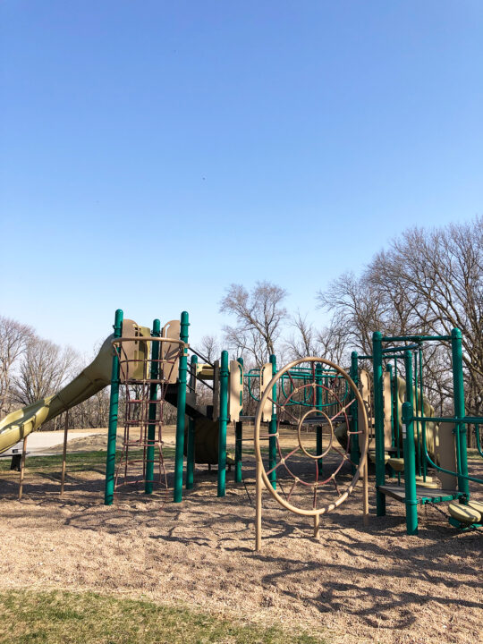 playground on gravel with climbing equipment ropes and slides