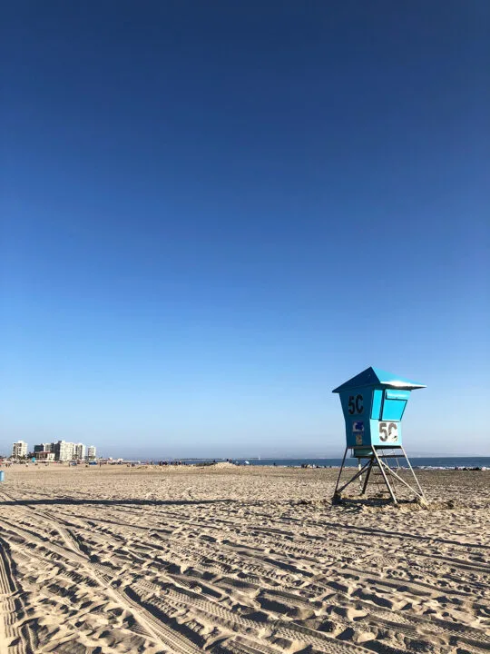 San Francisco to San Diego road trip view of beach with lifeguard tower towards sunset