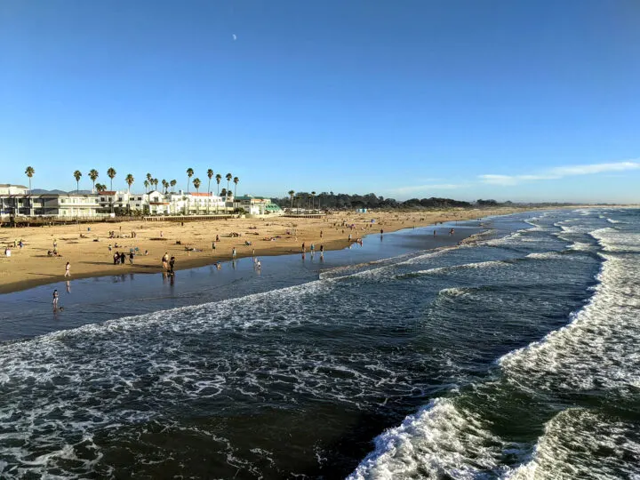 San Francisco to San Diego road trip stops - beach from the air waves lots of people and buildings in distance