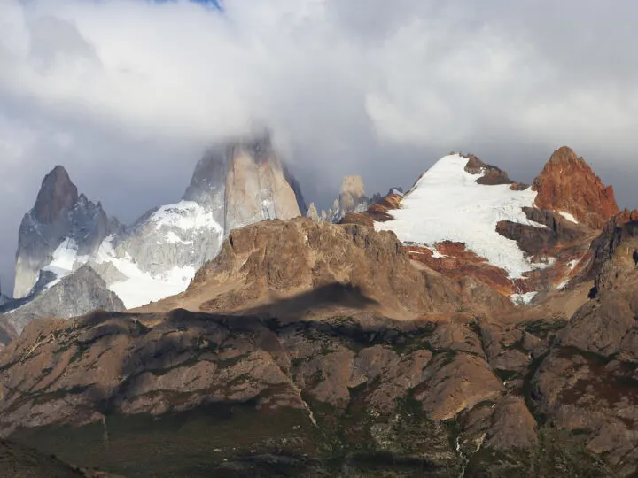 jagged peaks while with some snow grey and orange while on an adventurous bucket list vacation