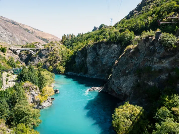 adventure ideas view of teal river rocky canyon and bridge in distance