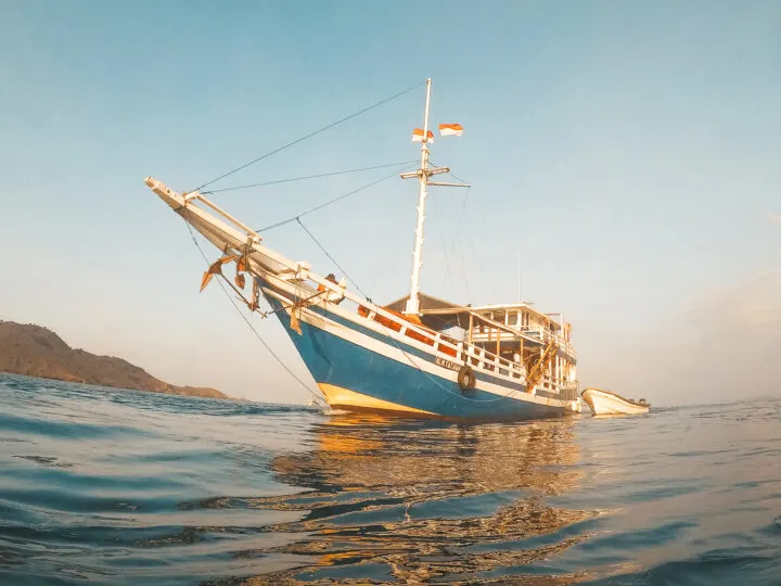 adventure ideas view of long boat from water with foggy view island in background