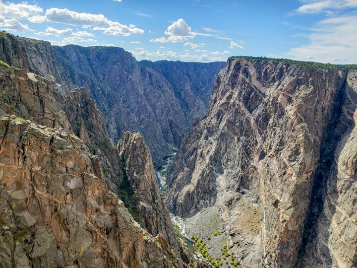 scenic drives colorado view of a huge canyon with jagged cliffs looking down to river below