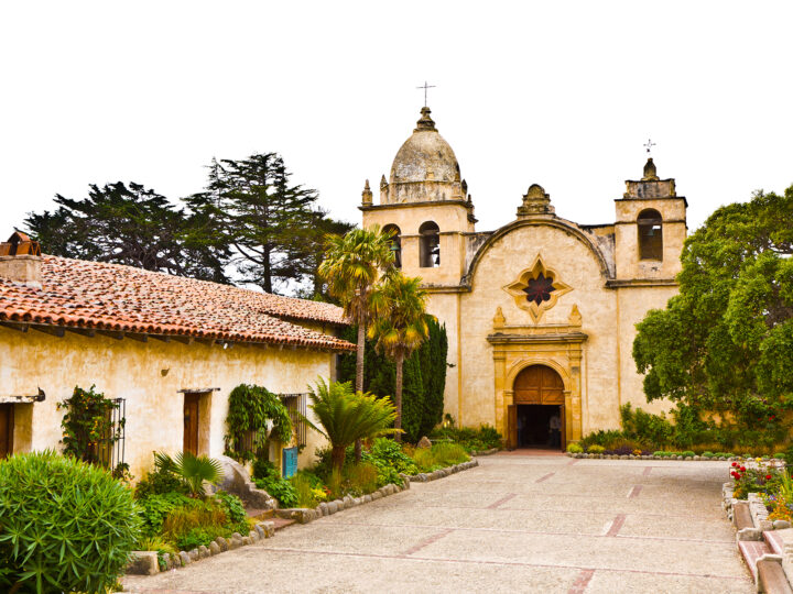 front of Carmel Mission Basilica Museum with old architecture and gardens