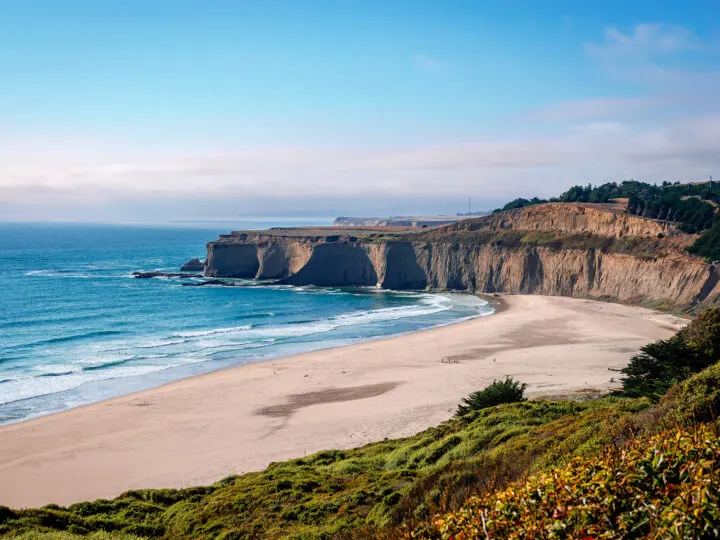 california road trip view of the half moon bay beach with cliffs in distance