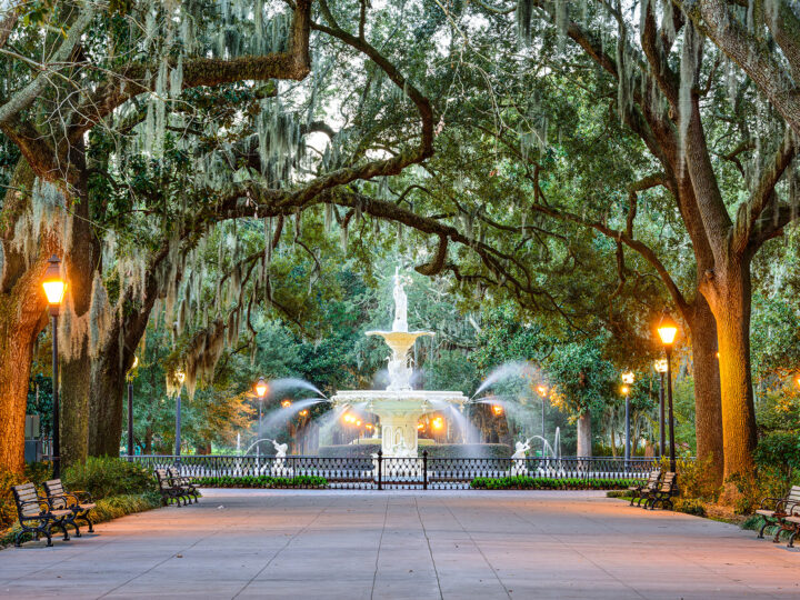 best place to vacation in September fountain and trees with fence and benches in Savannah
