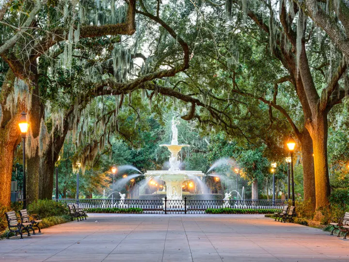 best place to vacation in winter USA fountain and trees with fence and benches in Savannah