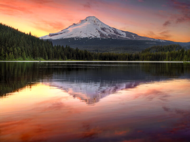fall vacation destinations USA mt hood Oregon with pink and orange sunset reflecting on lake white mountain peak