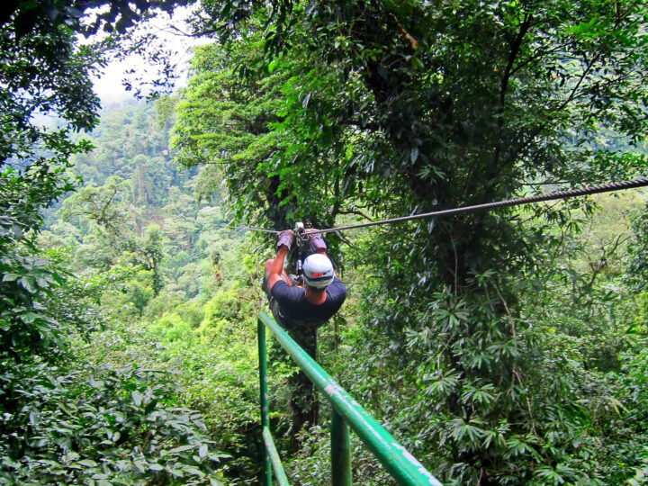 man ziplining in jungle of Costa Rica adventure bucket list