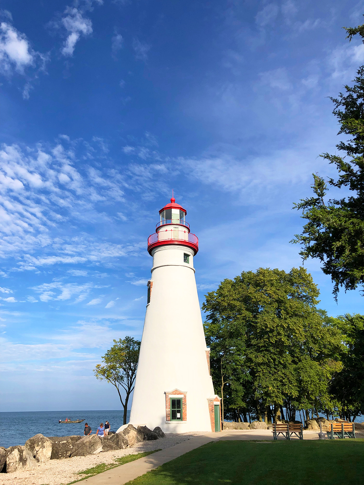 Best places to visit in September in USA view of lighthouse with white and red on coast in Ohio