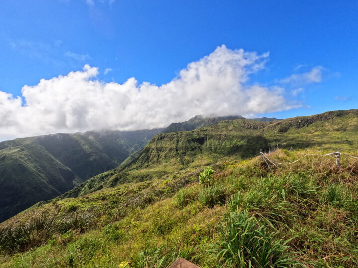 view of Waihe'e valley from summit beautiful valley with lush greenery white clouds blue sky
