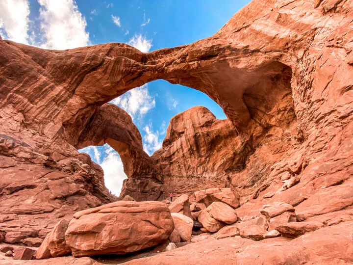 large red rock arch on sunny day