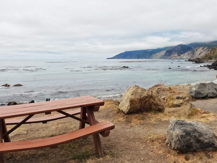 things to do in Big Sur have a picnic overlooking the coast with rocky cliffs Pacific Ocean on foggy day