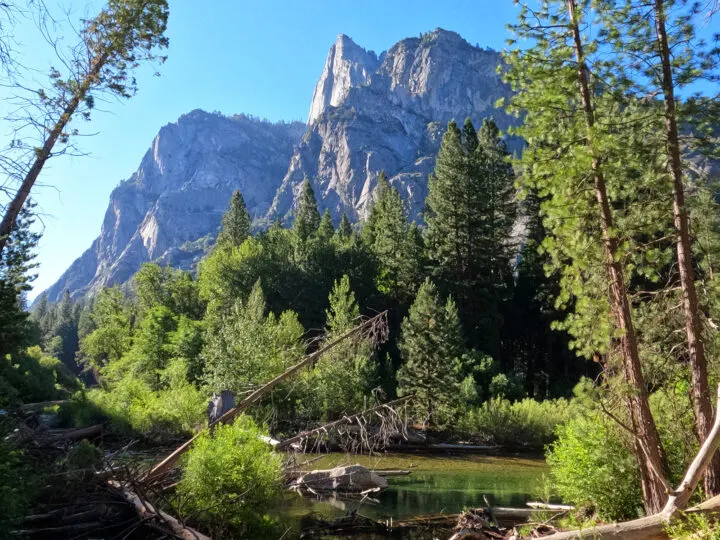 best national parks in October view of trees river and rocky peaks behind in Kings Canyon