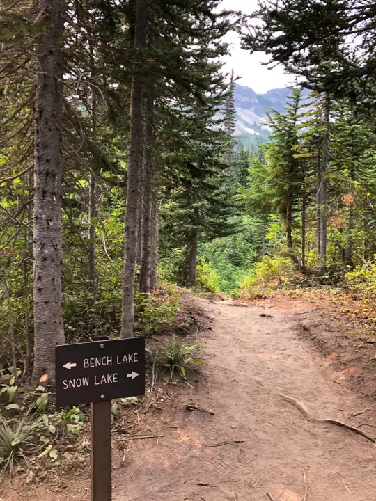 bench lake snow lake sign with hiking path