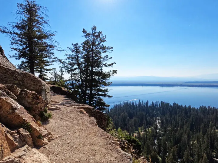 Grand teton inspiration point hiking trail with cliff overlooking Jenny lake