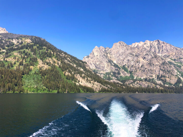 riding Jenny lake boat shuttle view of water and mountains across lake