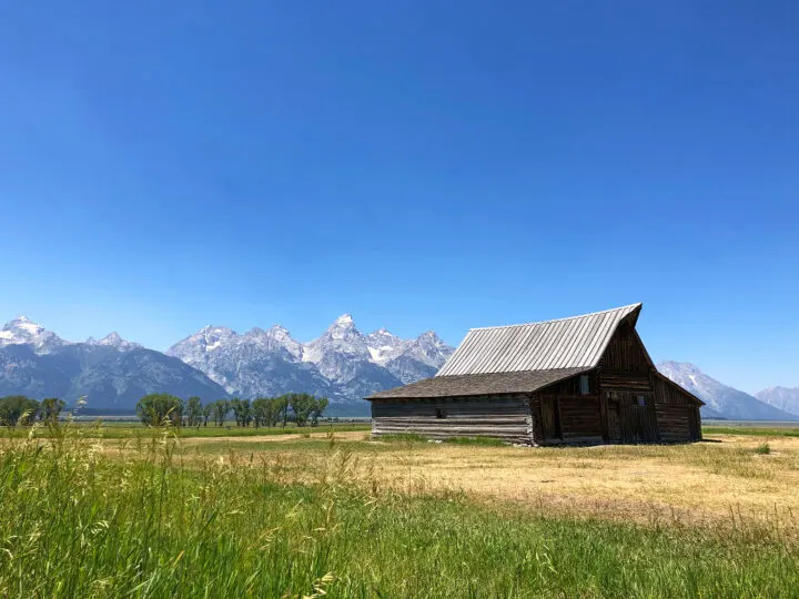 things to do in grand teton view of barn in field with mountains in distance