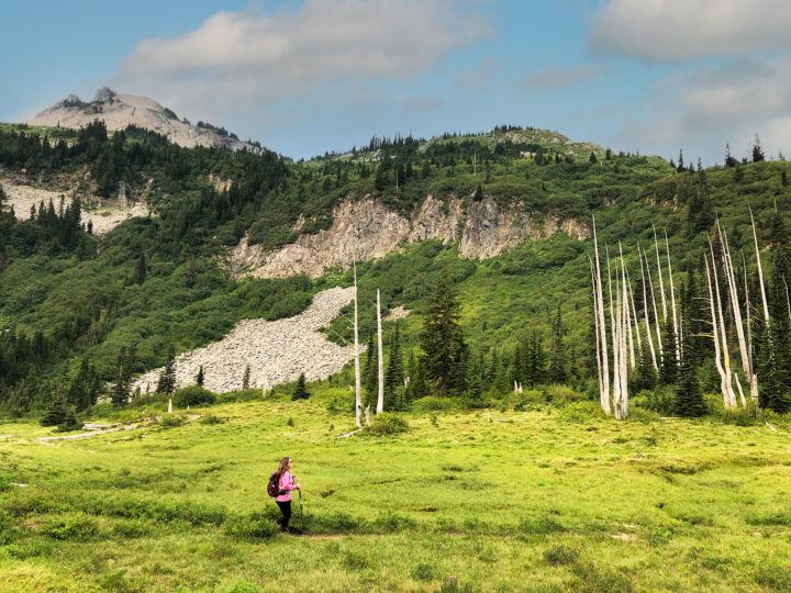 woman hiking in field at bench and snow lake trail mt rainier