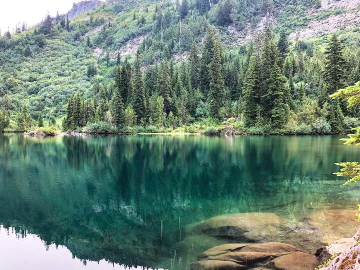 teal water clear base trees in distance at snow lake mt rainier