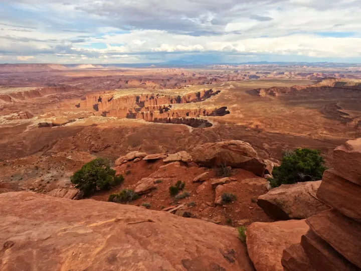 utah national parks tour view of rocky desert with large canyons in distance