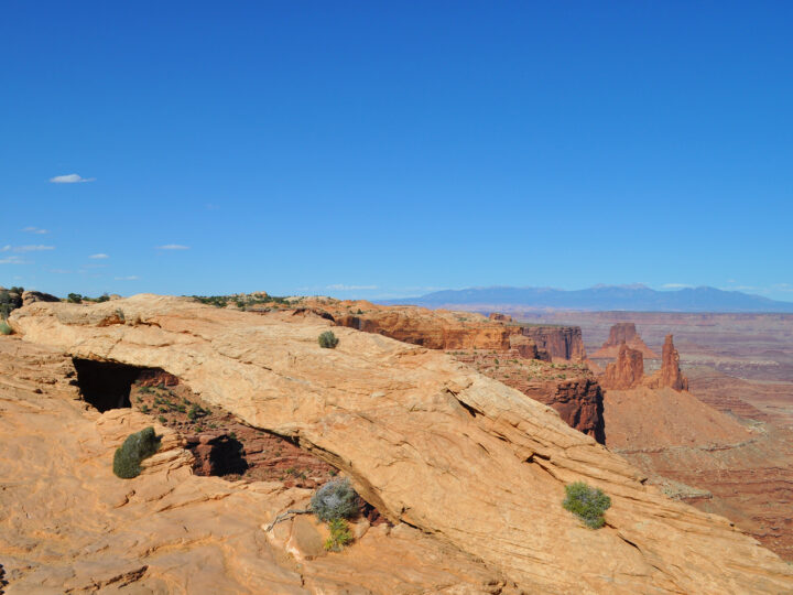view of rock arch with canyon in distance at canyonlands national park utah