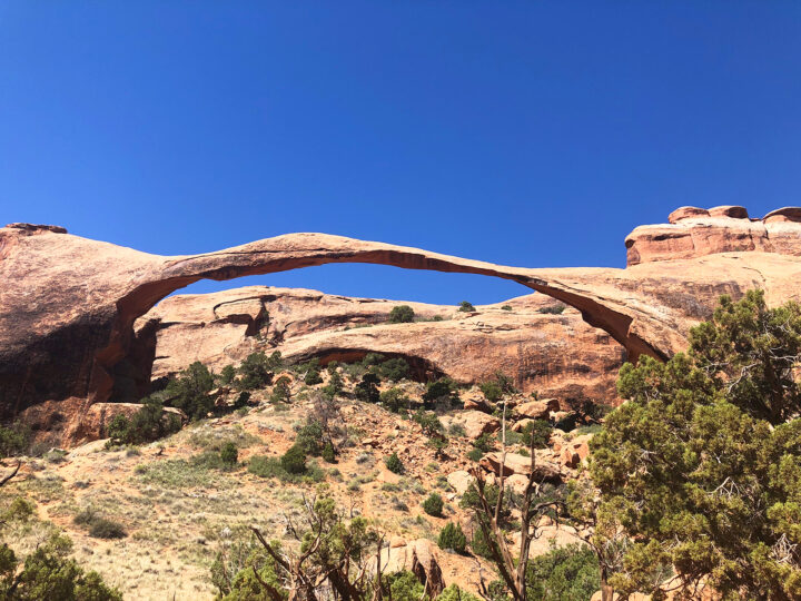 thin arch spanning over large area in desert scene