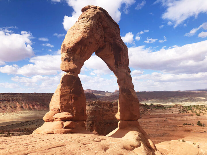 best national parks to visit in May view of large rocky arch with blue sky