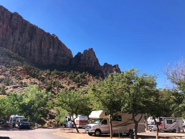 rvs in campground with large stones in distance