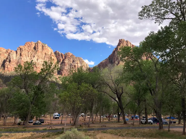 camping in Zion with kids view of watchman campground view of tents and cars under trees with canyon in distance