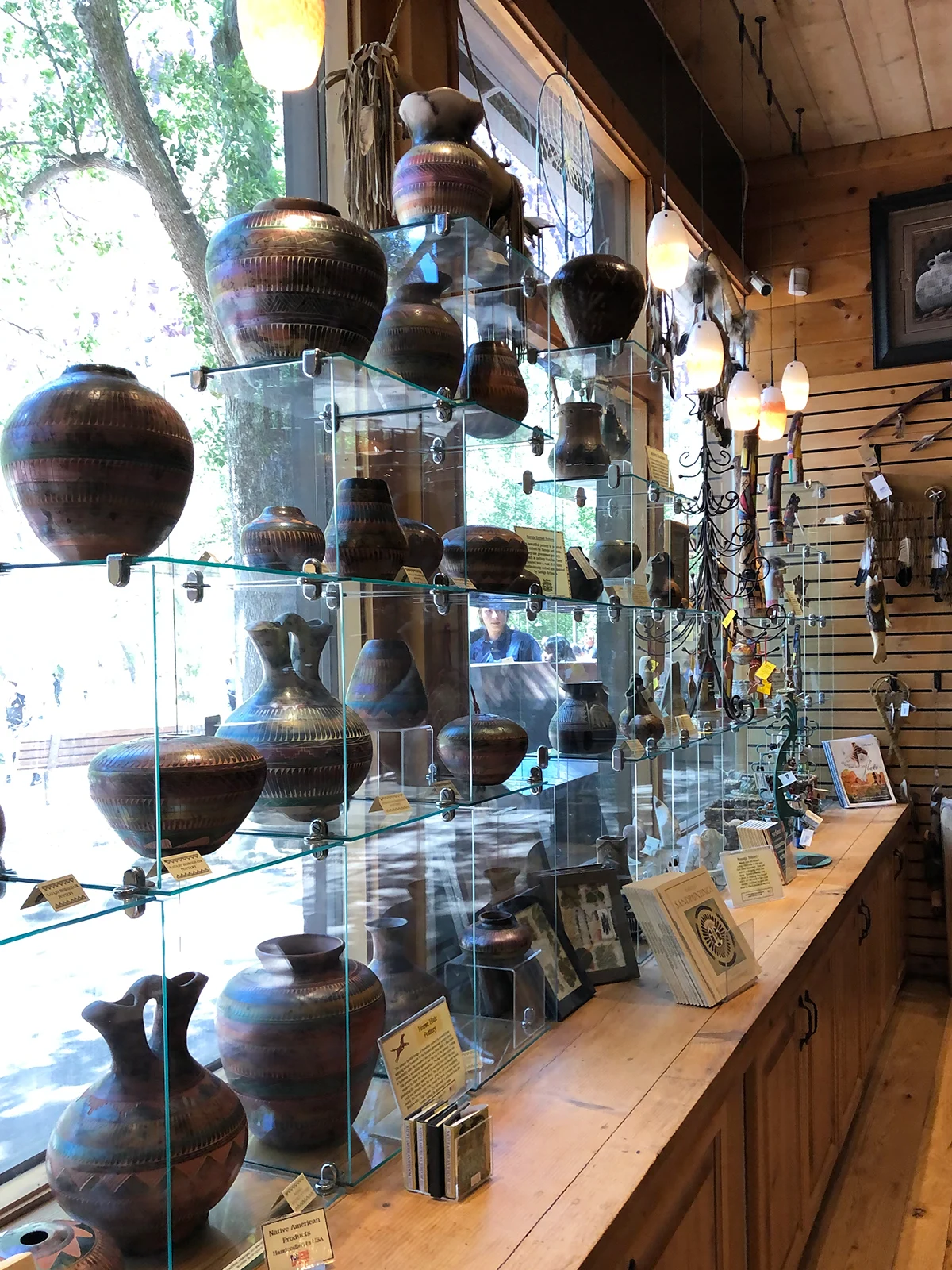 storefront with glass and pots on shelves