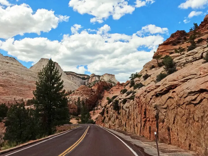 road through canyon with plateaus in distance mt Carmel scenic drive