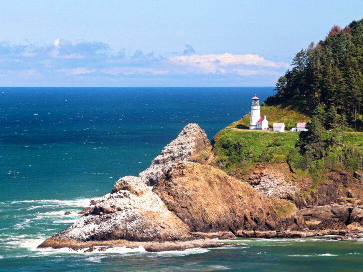 coastal waters with rugged cliffs lighthouse and blue ocean