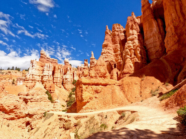 Queens Garden Trail Bryce Canyon view of hiking trail through orange rocky hoodoos on sunny day in Utah