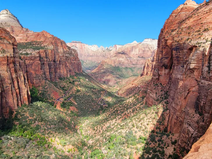 Canyon Overlook Trail Zion National Park view of massive canyon orange and red rocks with lush valley and road below