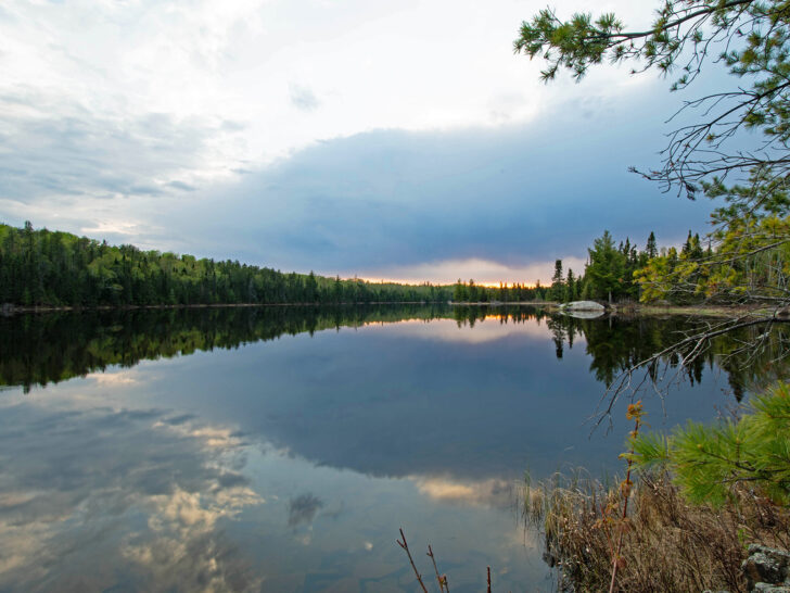 sunset at lake on Voyageurs dark sky greenery surrounding best national parks to visit in may