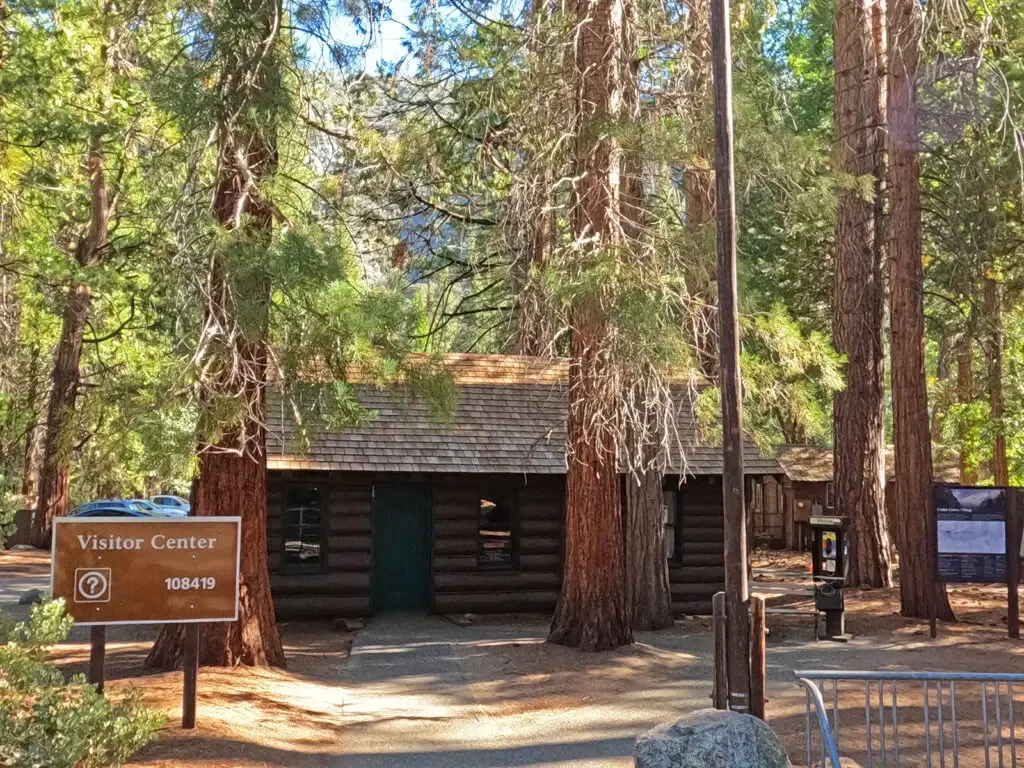 kings canyon visitor center log building with tall trees surrounding