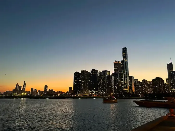 chicago skyline at night with water boats and skyscrapers start of route 66