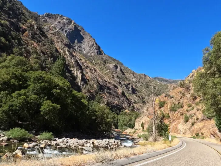 kings canyon national park things to do scenic road through canyon with river beside it blue sky