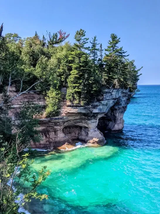 Pictured Rocks Michigan teal water along cliff with trees