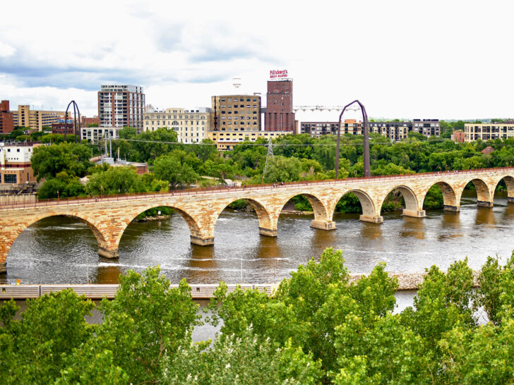 American roadtrip through upper midwest river and bridge with city skyline in distance
