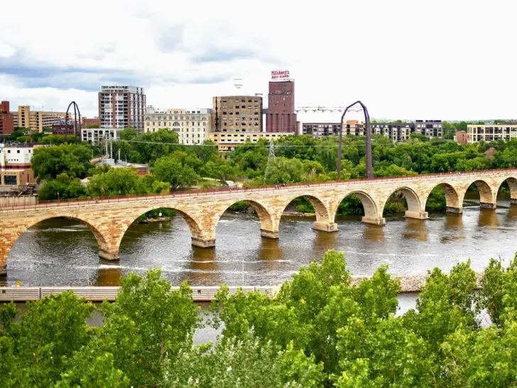 American roadtrip through upper midwest river and bridge with city skyline in distance