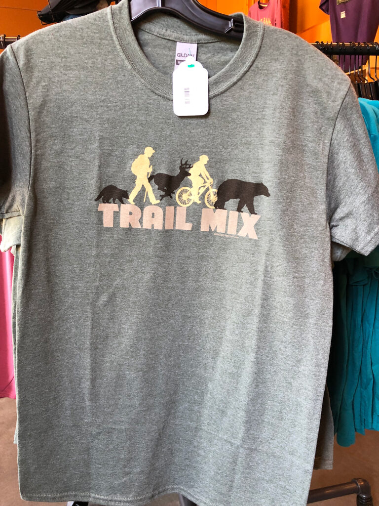 gray shirt that says trail mix including animals and people