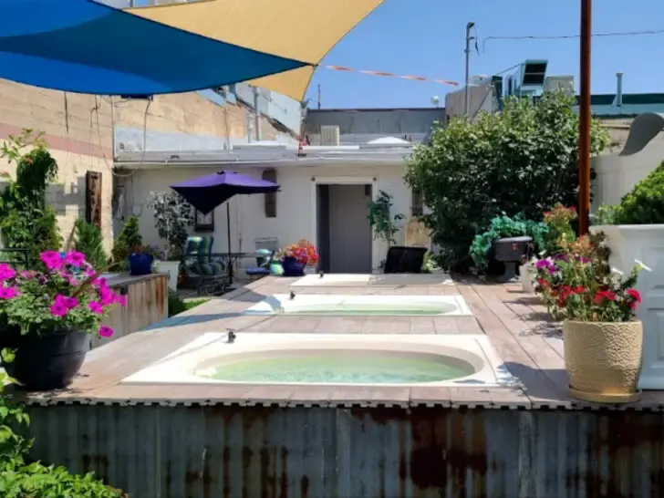 hot tubs built into platform with flowers