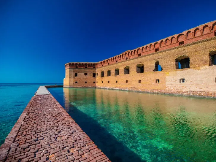 best national parks with kids dry tortugas in Florida with brick path over water and stone fort in distance
